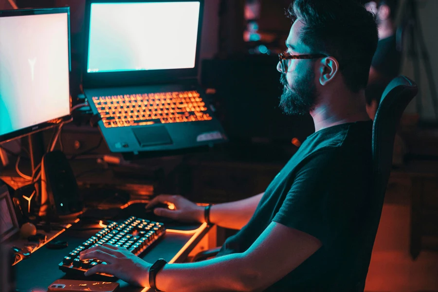 man in blue shirt using computer