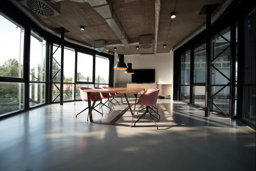 Photo of office chairs and a table in the middle of a pod