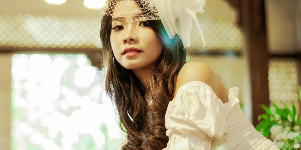 A beautiful Asian woman with long hair and a decorative hairpiece in an elegant setting