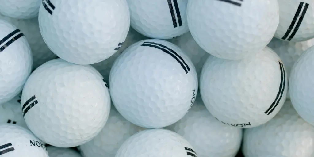 Primer plano detallado de una pila de pelotas de golf, ideal para temas deportivos. Ideal para los amantes del golf.