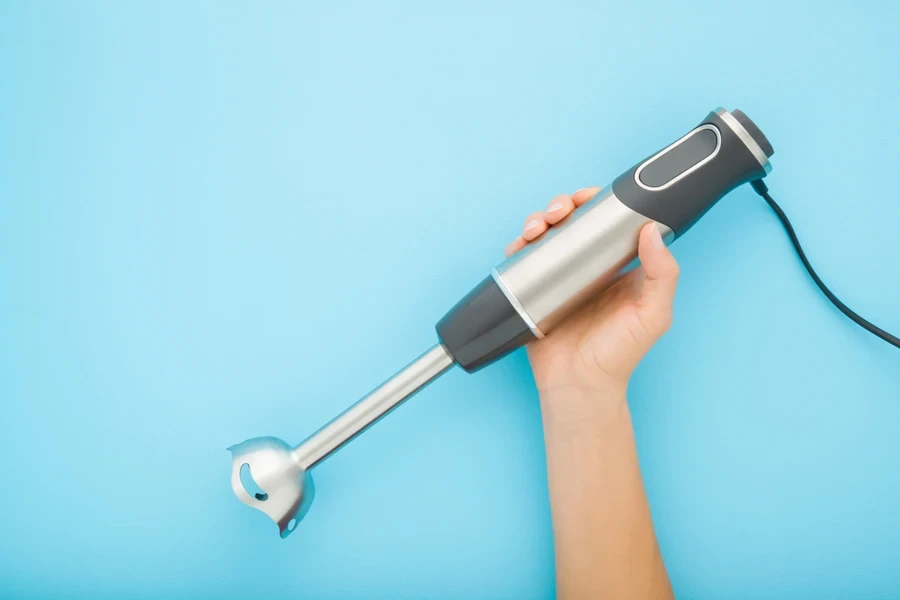 A hand holding a clean immersion blender