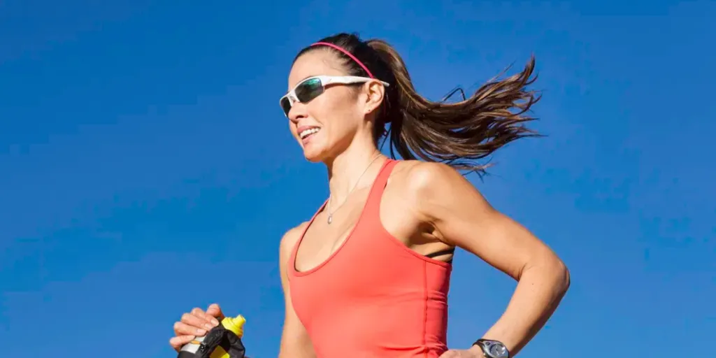 A healthy woman running outside