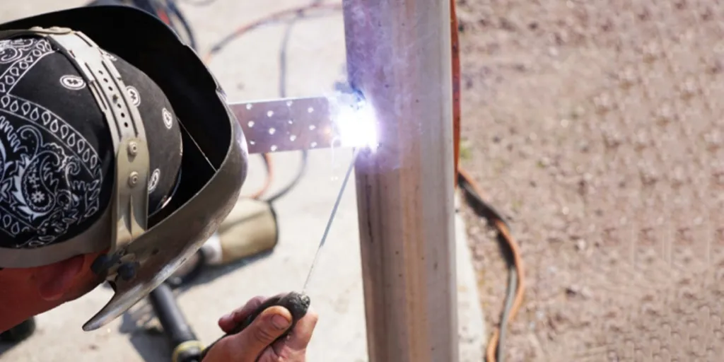 A man using a miniature welder.