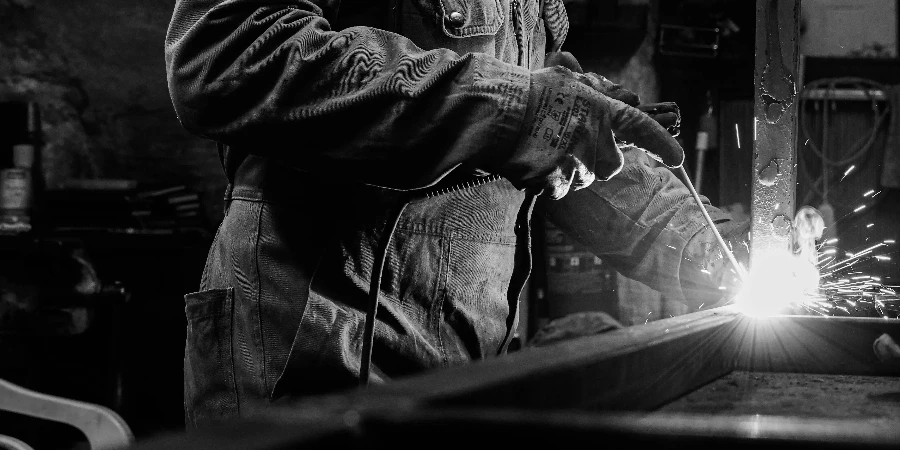 A skilled artisan working in an İstanbul workshop captured in striking black and white emphasizing light contrast by Mesut Ylcn