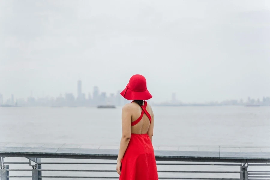 A woman wearing a red gown and hat