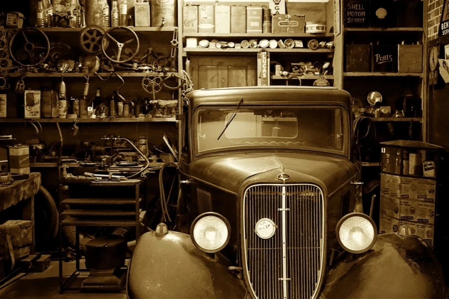 An ancient garage with a vintage car parked inside