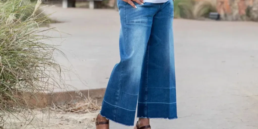 Beautiful senior woman with hands on hips smiles while looking at the camera