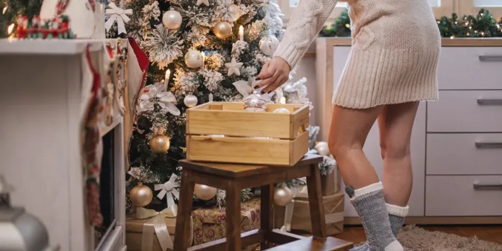 Beautiful woman preparing her home for Christmas holidays