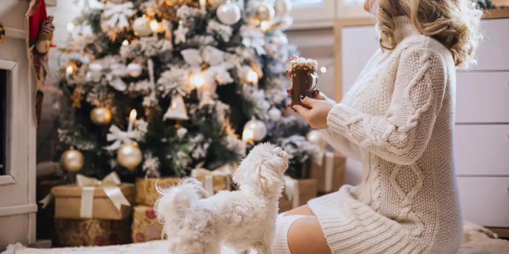 Beautiful woman relaxing at home while drinking hot chocolate in a cozy Christmas atmosphere