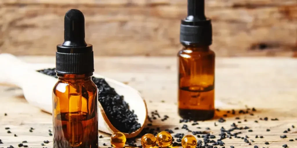 Black cumin essential oil in a small bottle