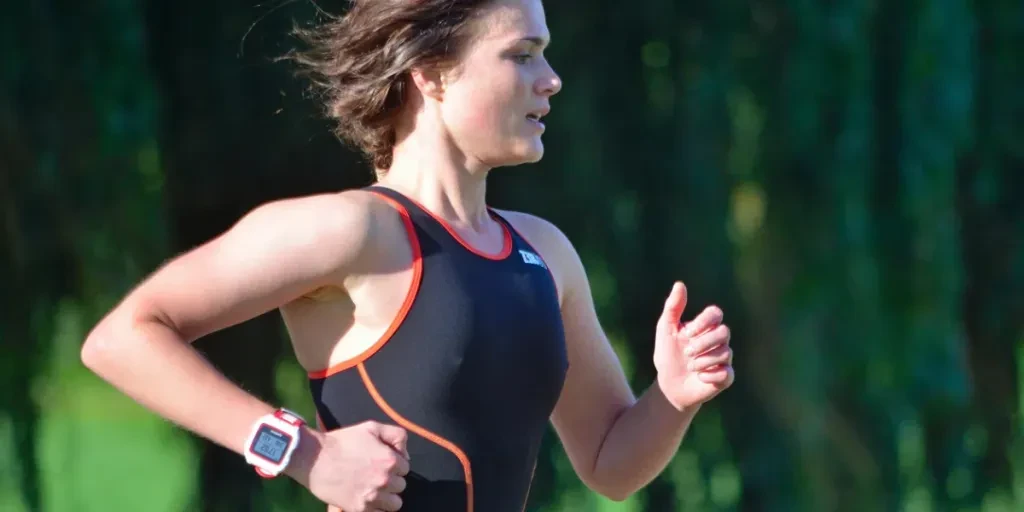 Close up of Female Triathlete running in Black Skinsuit