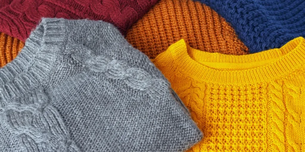 Concept knitted wool colorful warm sweaters closeup