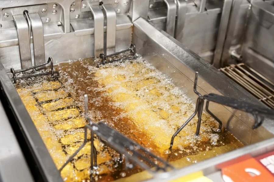 Deep fryer with boiling oil on restaurant kitchen1