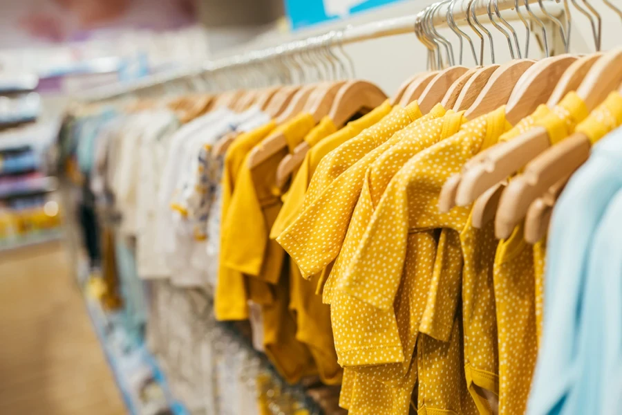 Different clothes hanging on display