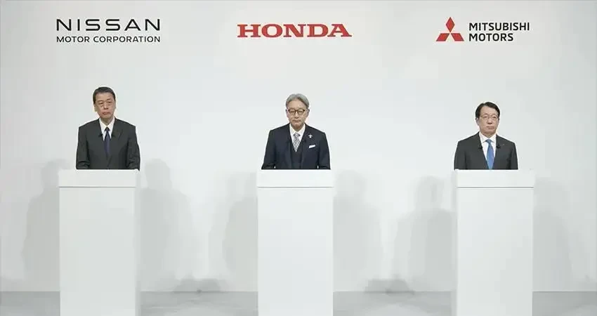 Executives from Honda, Nissan, and Mitsubishi at a press conference.