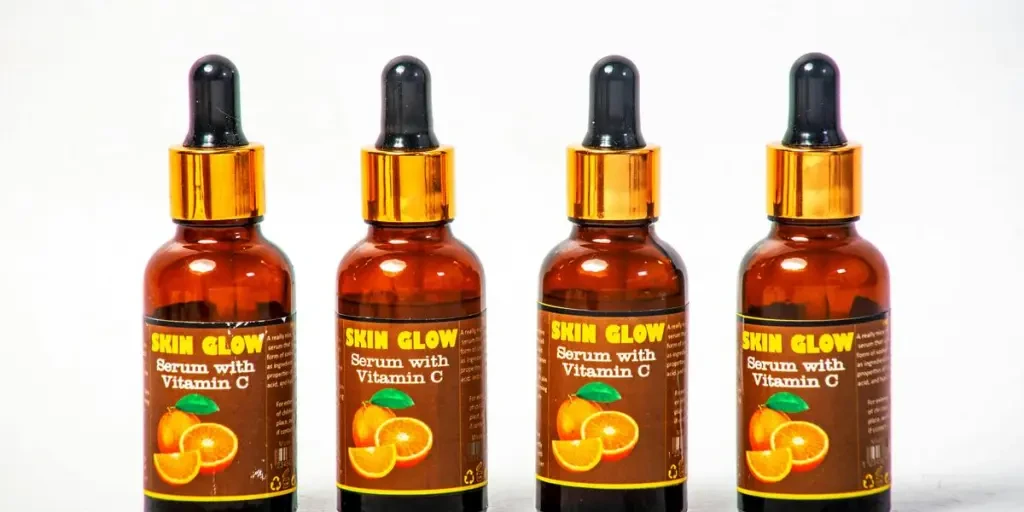 Four Vitamin C serum bottles arranged on a white background for skincare