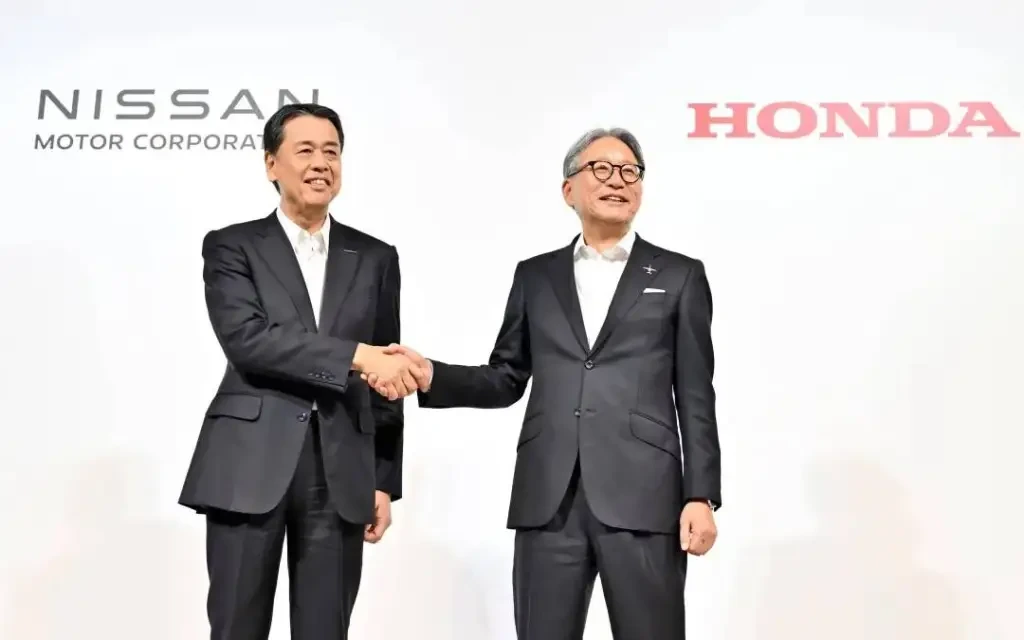 Honda and Nissan logos with a handshake symbolizing partnership.