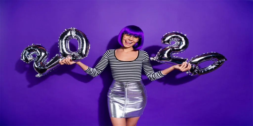 Photo of funny lady hold hands ballons new year party wear specs, skirt striped pullover isolated purple background