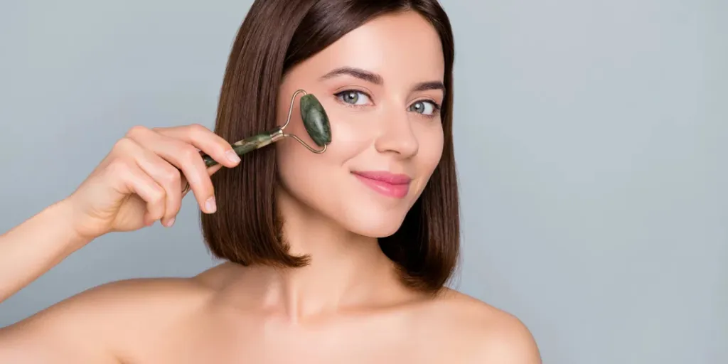 Photo of happy lady use gua sha jade massage want silky soft skin isolated over grey color background