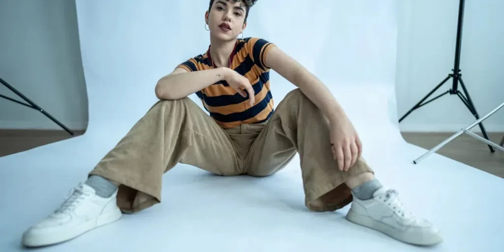 Portrait d'une jeune femme mannequin assise par terre en studio