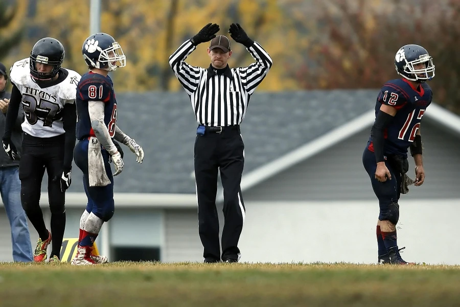 L'arbitro chiama timeout durante un'intensa partita di football del liceo all'aperto