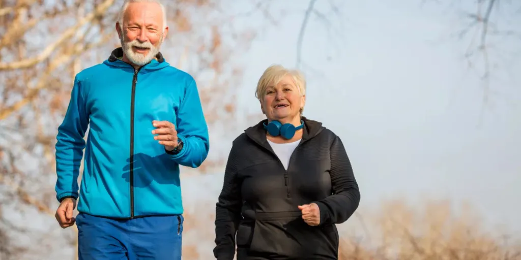 Senior couple is jogging, smiling and enjoying in beautiful sunny day