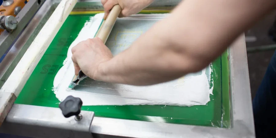 Serigraphy silk screen print process at clothes factory