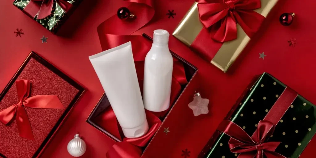 White bottles cosmetic products in red giftbox and on red background