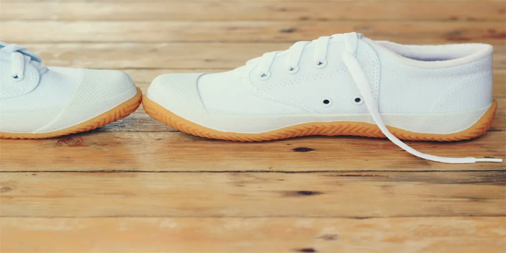 White sneakers on wood background, vintage tone