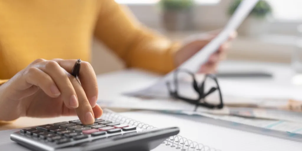 Woman calculating revenue in an office