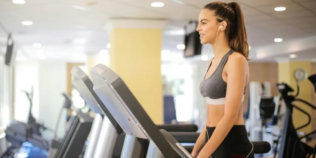 Woman enjoying a workout on a treadmill indoors, promoting fitness and health