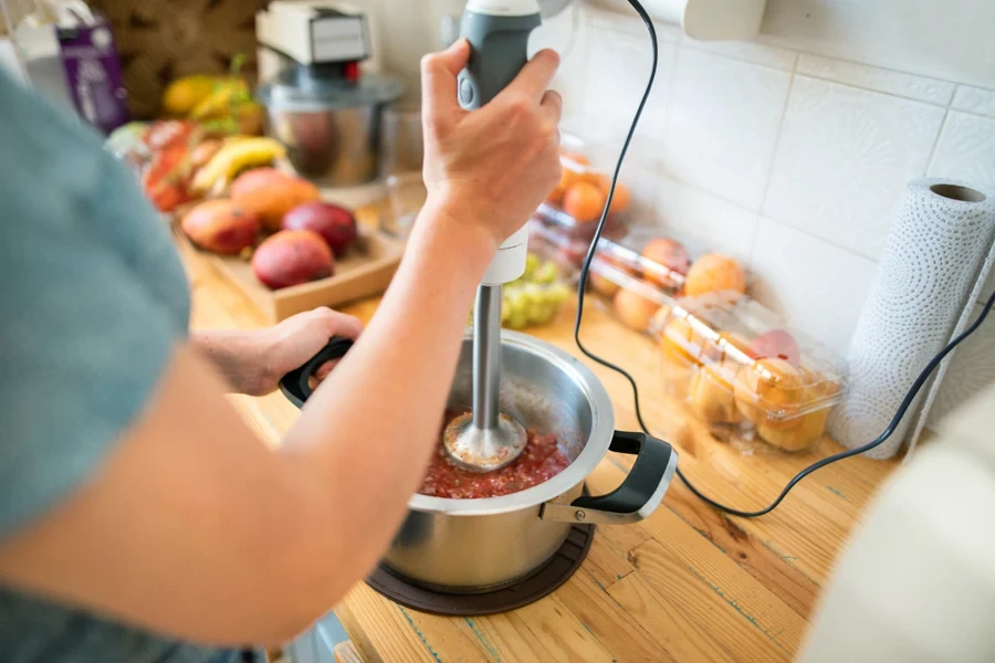 Woman using an immersion blender directly in a pot