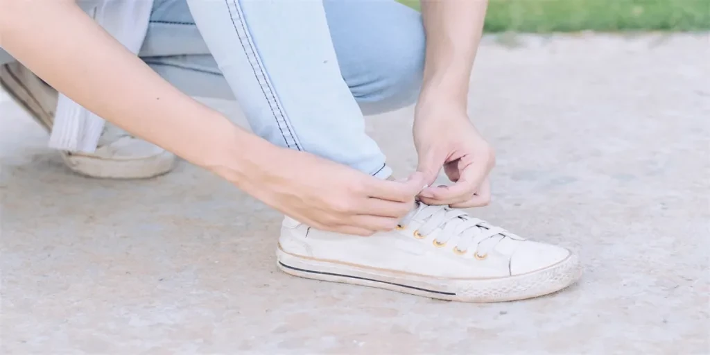 Women are tying a shoelace