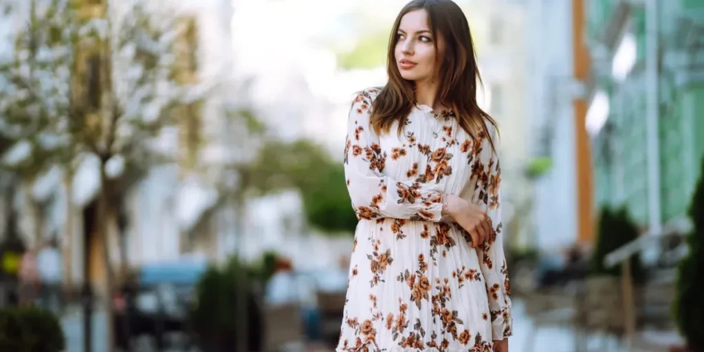 Young woman in a beautiful dress posing on a city street