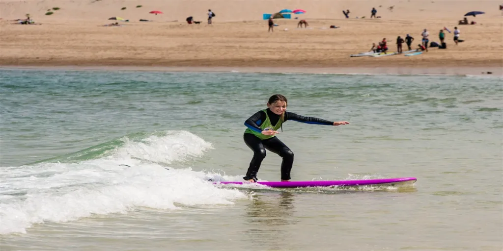 cute smiling girl riding a small wave