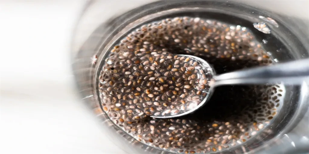 op view on glass containing chia seeds gel with partially submerged spoon