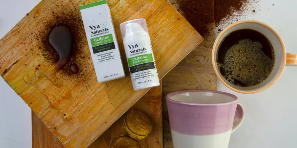 two green and white bottles with box beside mugs