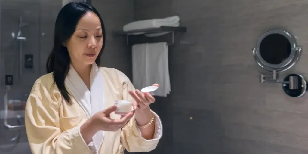 woman applying facial cream