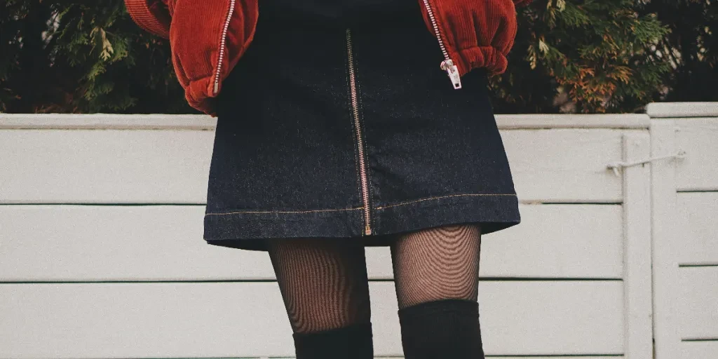 woman wearing black denim skirt and thigh high socks by Oleg Ivanov