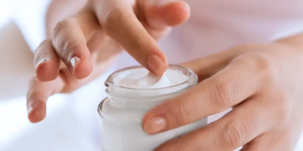 woman's hand touching on the cream for applying