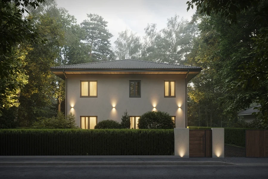 A bungalow with outdoor bug lights surrounded by trees