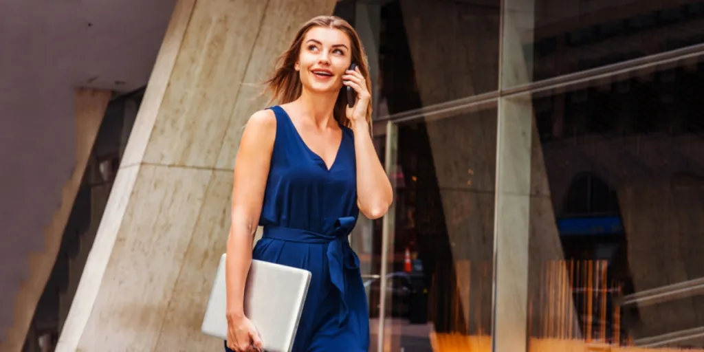 A busy woman in a blue v-neck dress