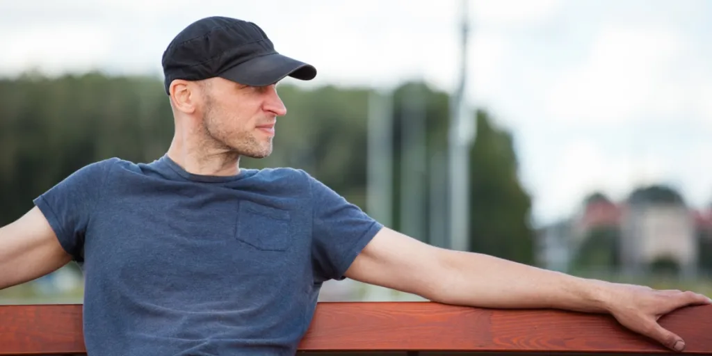 A man wearing a black 5-panel hat