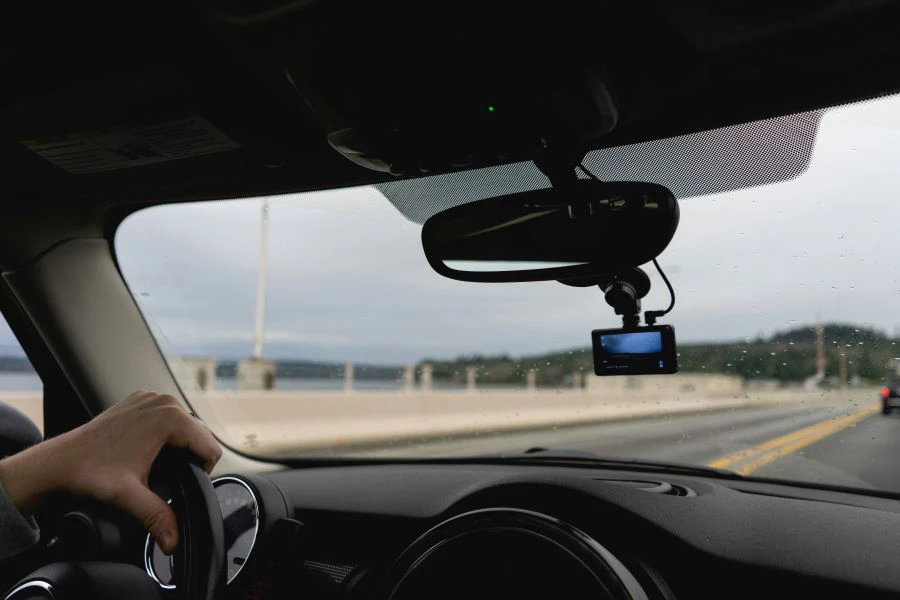 A person driving a car with a dashcam