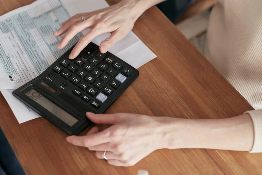 A person holding a calculator doing some calculation