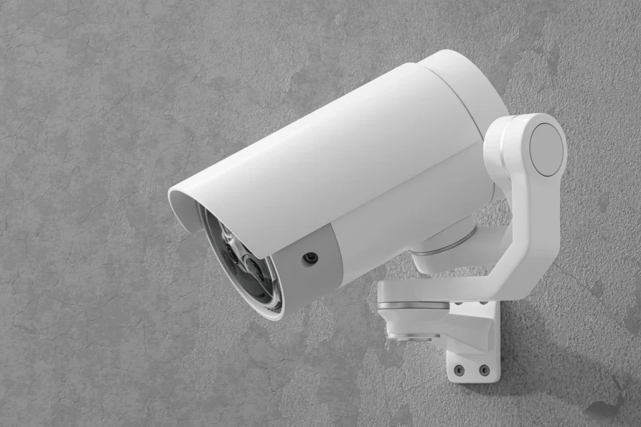 A white CCTV camera mounted on a wall