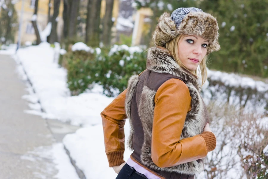 A woman wearing a cropped wool and corduroy vest