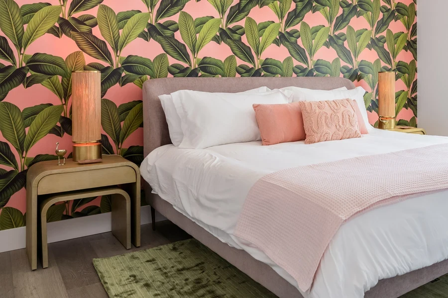 Bedroom with an accent wall with tropical wallpaper