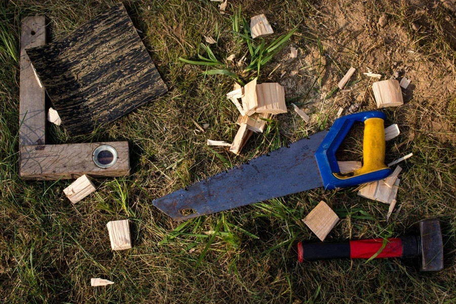 Blue wood hacksaw on grass