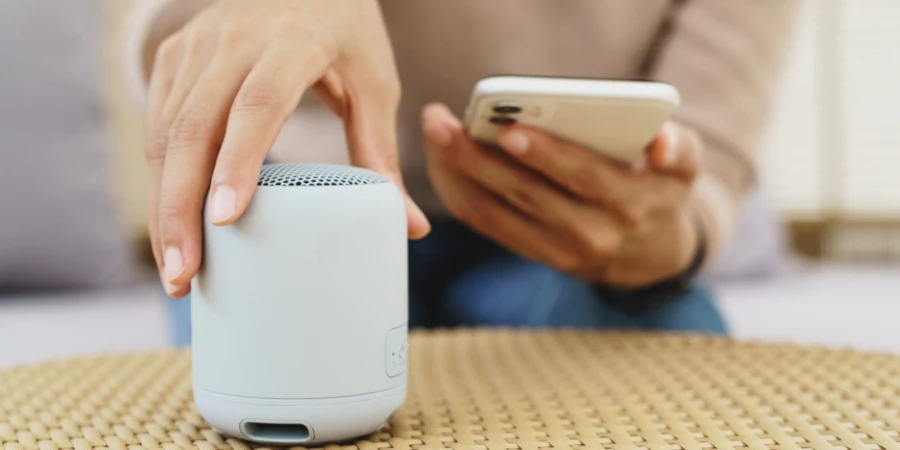 Close-up on hand using phone connecting speaker bluetooth